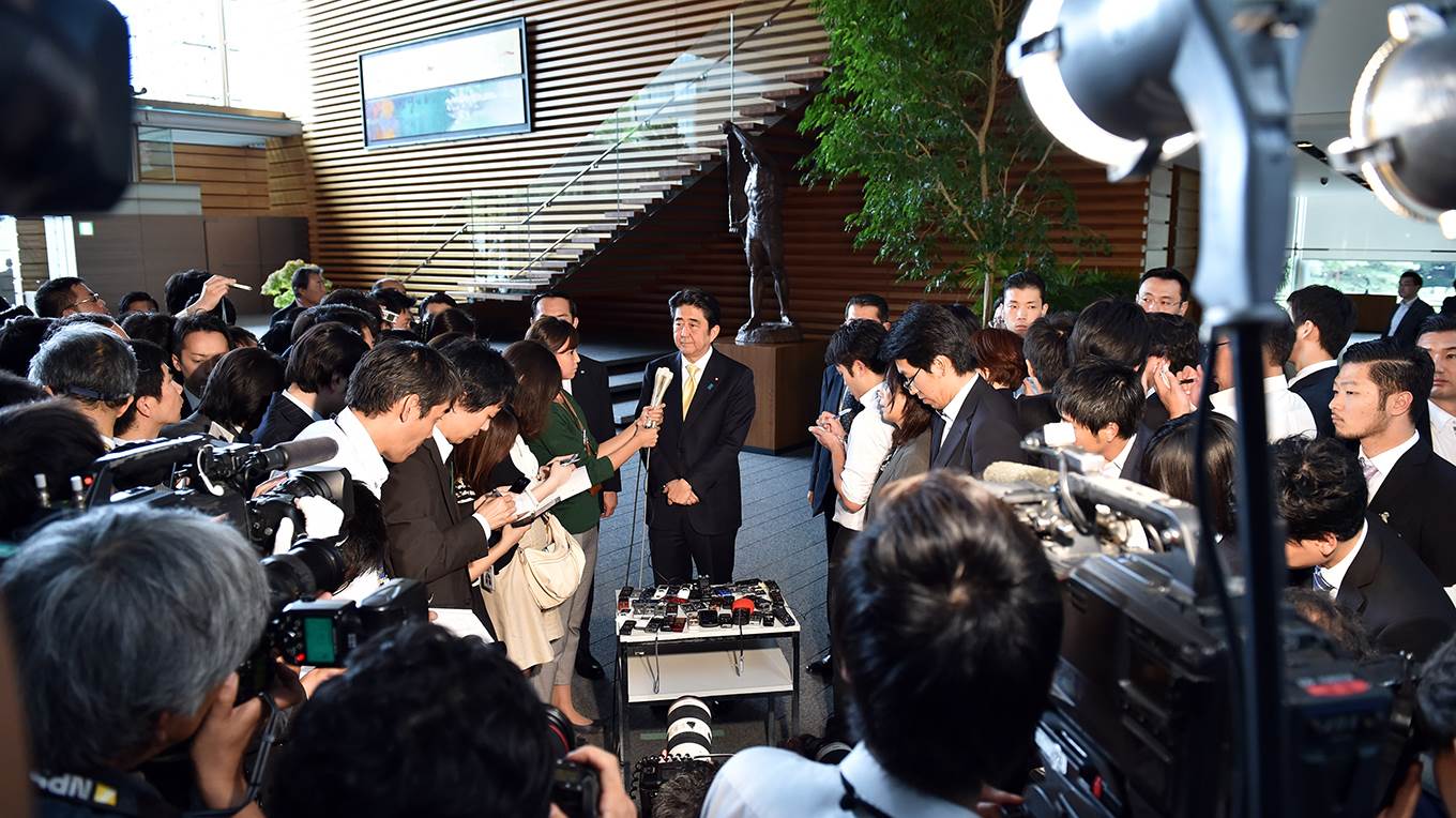 Japanese Prime Minister Shinzo Abe answers questions during a short press interview