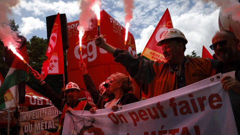 ArcelorMittal workers hold flares outside France’s National Assembly in Paris during a demonstration calling for the nationalisation of the steelmaking company.