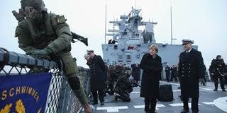  German Chancellor Angela Merkel watches as a member of the German Navy's Special Forces boards from a speedboat
