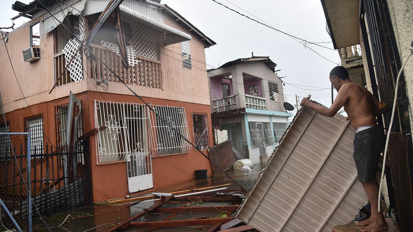 Residents of Puerto Rico deal with damages to their homes as Hurricane Maria batters the island