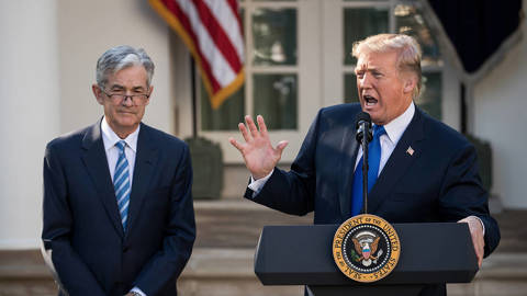 Trump and Powell at a press conference.