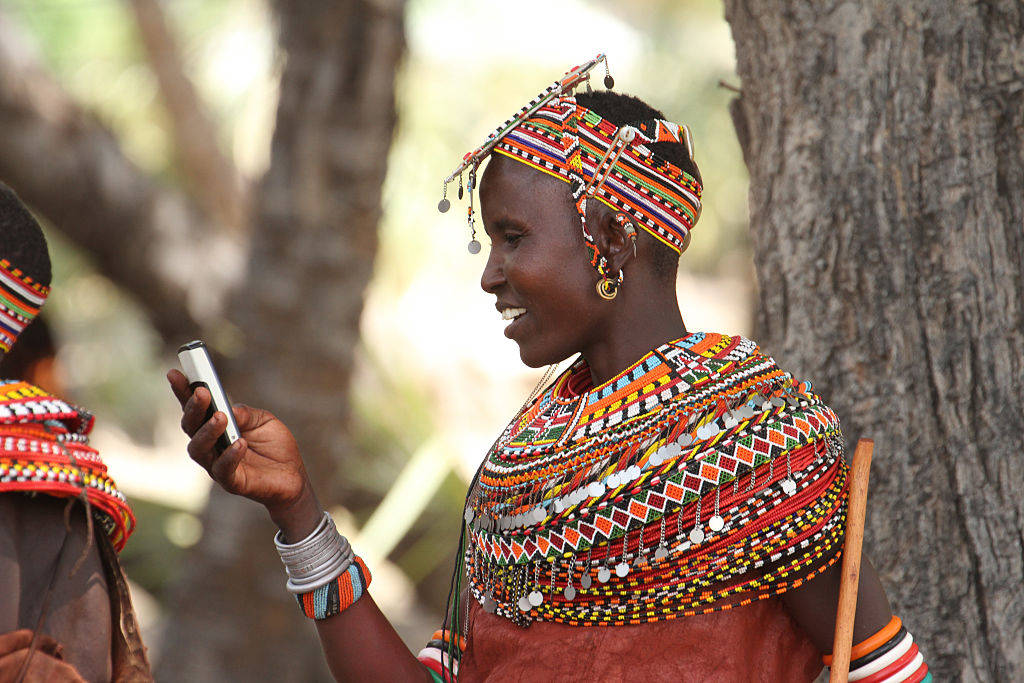Samburu woman uses mobile phone in North Kenya before Lake Turkana Festival