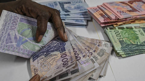 Different denominations of West African CFA franc banknotes arranged for an illustration photo in Abidjan, Côte d’Ivoire, on March 27, 2024. The image highlights the regional currency used by member states of the West African Economic and Monetary Union, amid debate in Senegal following the election of President Bassirou Diomaye Faye and discussion about the future of the CFA franc.