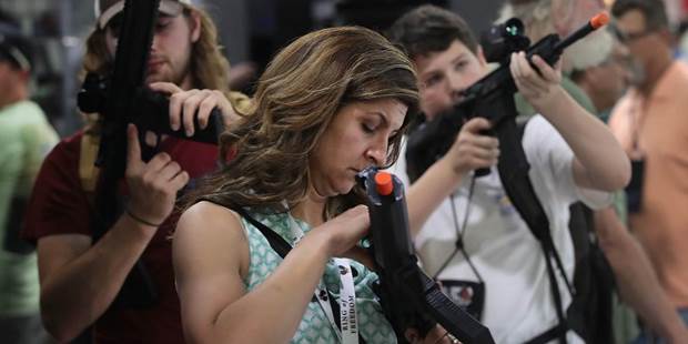 National Rifle Association members look over optics in the SIG Sauer display 