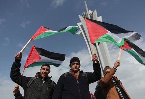 Palestinians holding flags