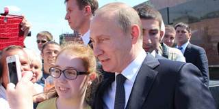 Vladimir Putin with female Russian child in Red Square.