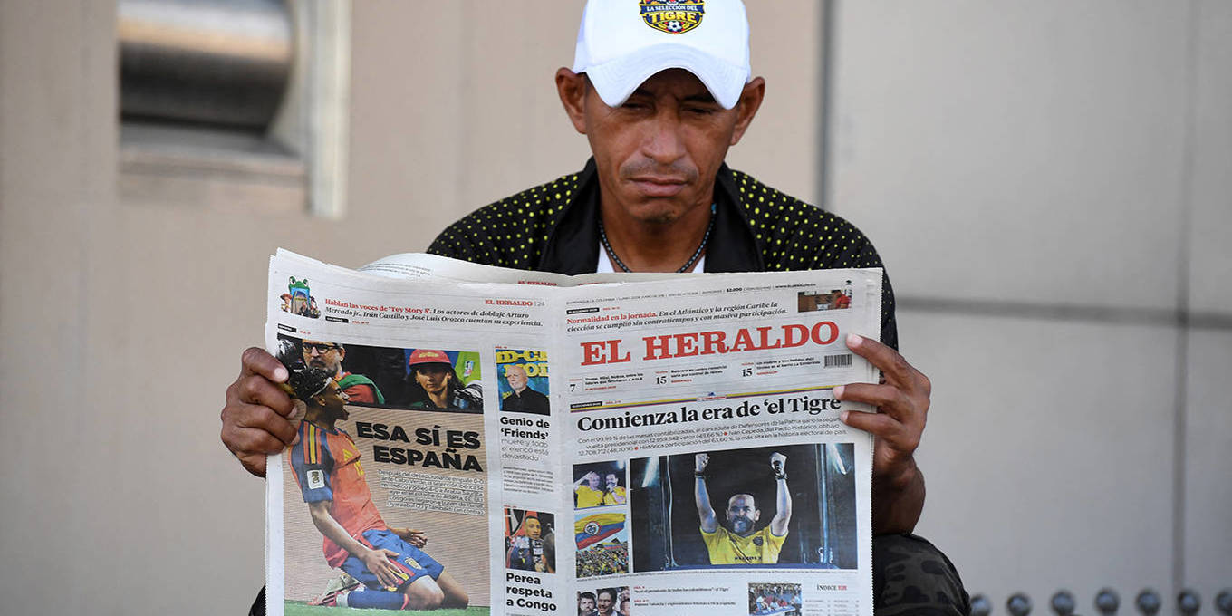 A man reads a newspaper featuring Colombia President-elect Abelardo de la Espriella the day after the 2026 presidential runoff election in Barranquilla, Colombia.
