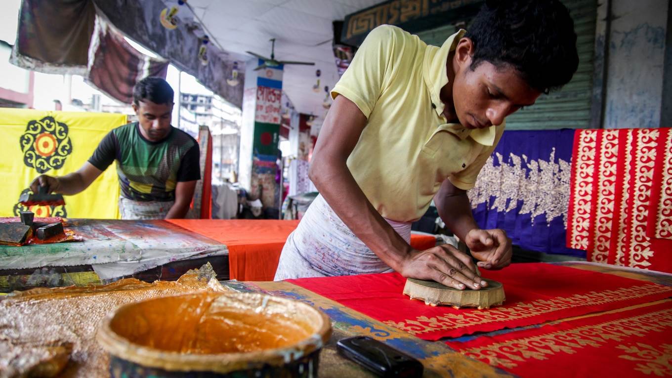 Local workers making clothes from hand painted cloth