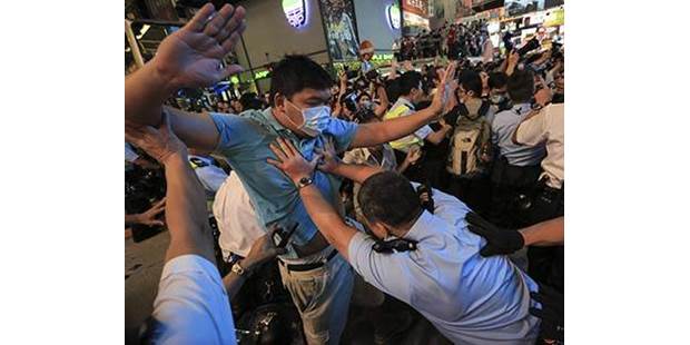 Hong Kong police clash protester