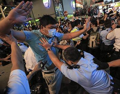 Hong Kong police clash protester