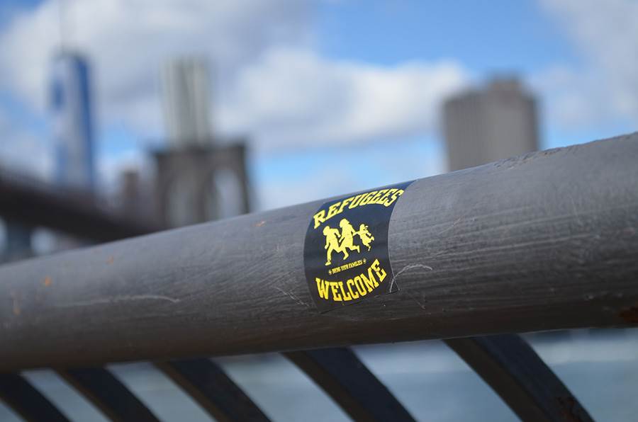 Refugees Welcome sticker on city handrail