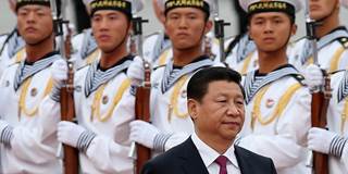 Chinese People's Liberation Army navy soldiers of a guard of honor look at Chinese President Xi Jinping