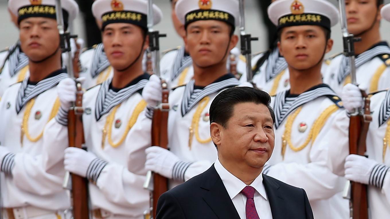 Chinese People's Liberation Army navy soldiers of a guard of honor look at Chinese President Xi Jinping