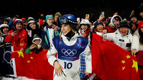 Skier Eileen Gu with fans at 2026 Olympics.