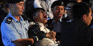 Pro-democracy activist Joshua Wong yells as he is taken away by police