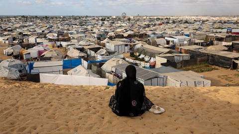 Woman overlooks Gaza camp for displaced people