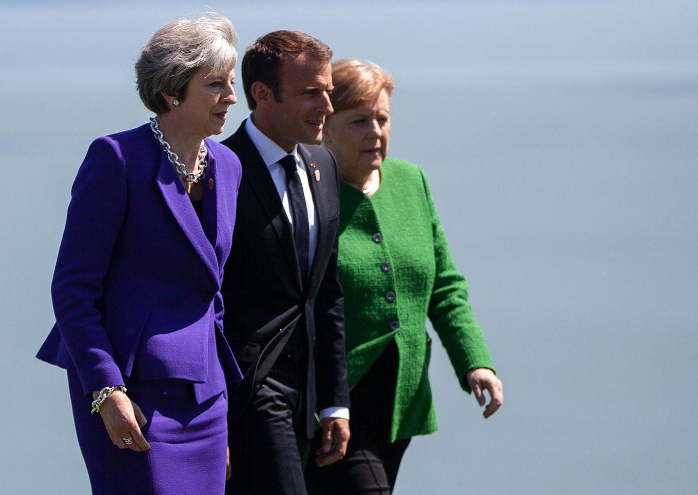 theresa may emmanuel macron angela merkel walking