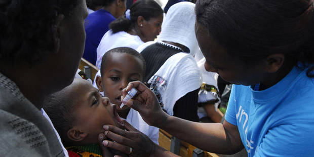 Health workers in Africa administering polio vaccine