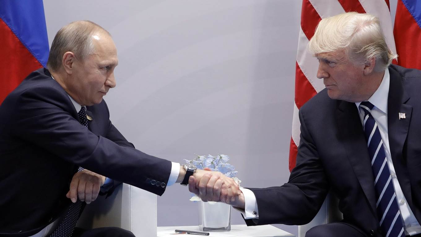 Russia's President Vladimir Putin and US President Donald Trump shake hands