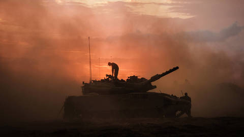 battle tank with soldier standing on it during sunset in israel