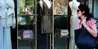  Luxury clothing is displayed in a window along Madison Avenue
