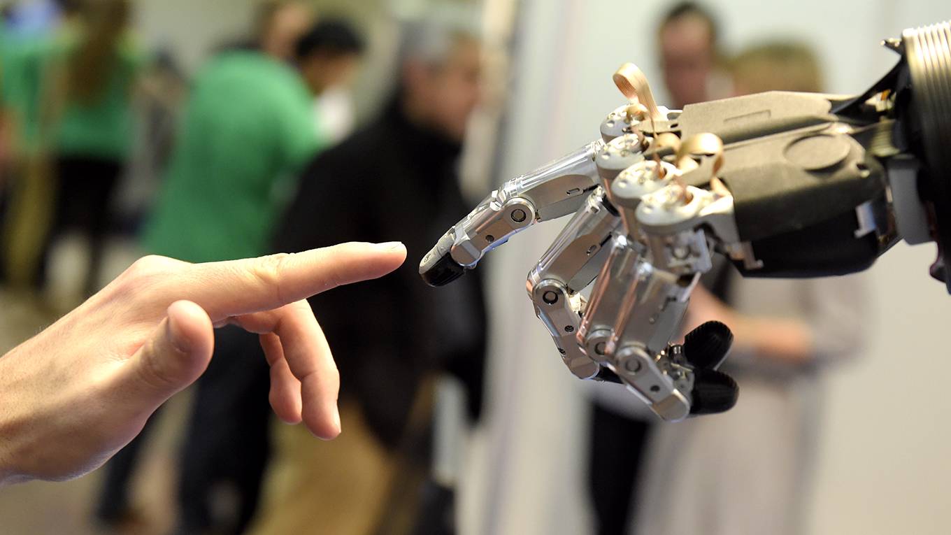 coyle8_GERARDJULIENAFPGettyImages_robothumantouchingfingers