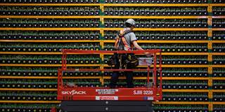 A technician inspects the backside of bitcoin mining at Bitfarms in Saint Hyacinthe