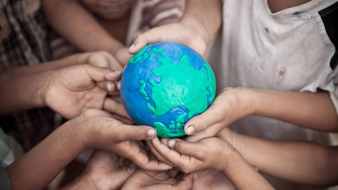 our planet topic_ woraputGetty Images_childrenholdingearth