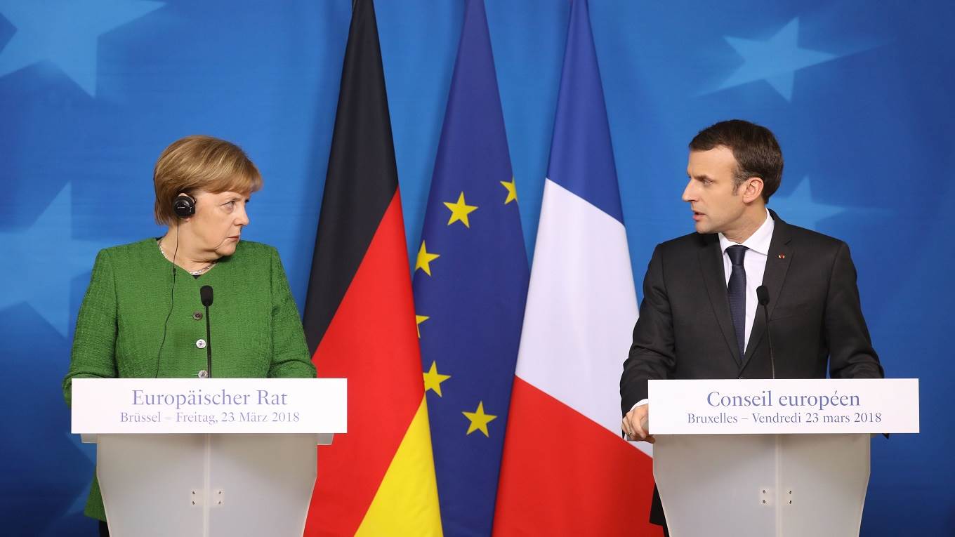 French president Emmanuel Macron delivers a speech during a joint press conference with Germany's Chancellor Angela Merkel
