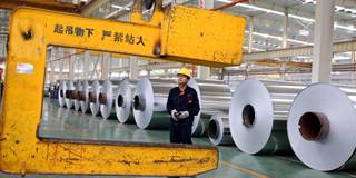 Chinese worker loading aluminium tapes at an aluminium production plant in Huaibei