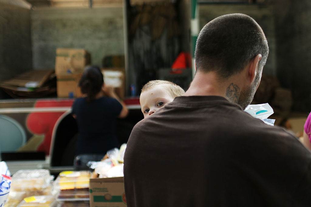 Poor man with baby at NY
