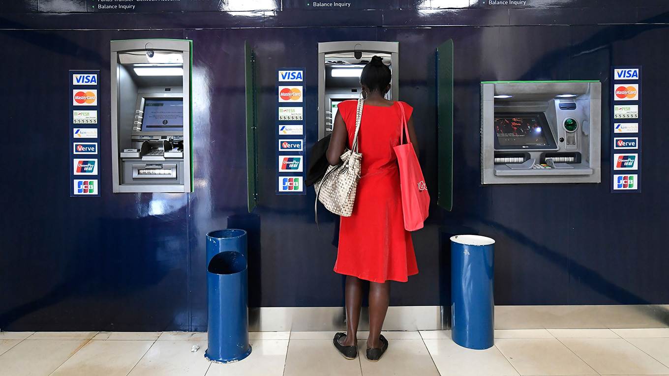 A woman uses an ATM machine at the Kenya Commercial Bank