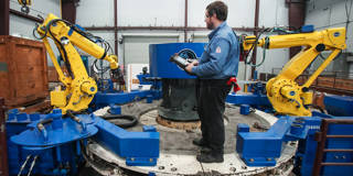 ltobin2_Brett CoomerHouston Chronicle via Getty Images_USmanufacturingrobot