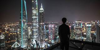 man looking at skyline chinese city