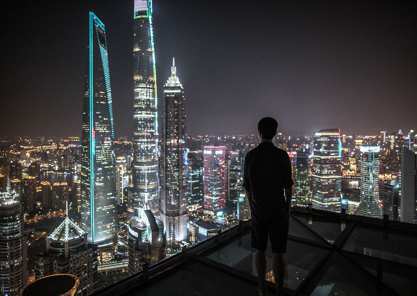 man looking at skyline chinese city