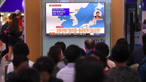 People watch news about North Korea