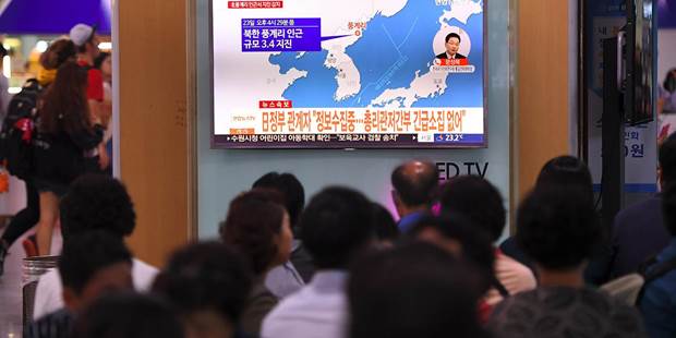 People watch news about North Korea