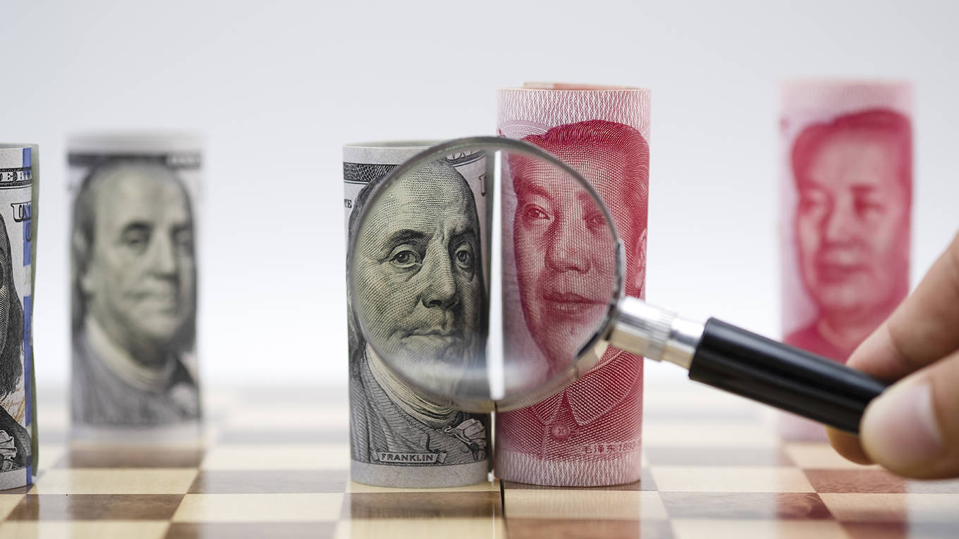 basu44_GettyImages_magnifyingglasschessboarddollaryuan