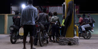 Customers queue at a petrol station in Lagos, Nigeria, amid fuel shortages and rising prices linked to global supply disruptions.