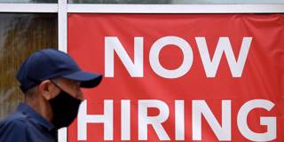 delong236_OLIVIER DOULIERYAFP via Getty Images_now hiring sign employment