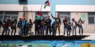 Students at United Nations Relief and Works Agency for Palestine Refugees (UNRWA) wave Palestinian flags during a protest against U.S. move to cut funding for UNRWA 