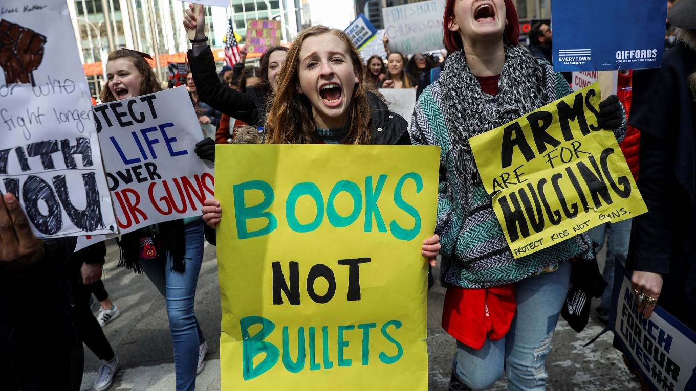 Protestors shout as they march down Sixth Avenue during the March For Our Lives