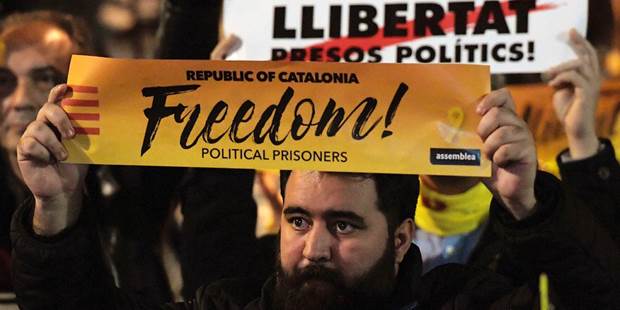 Protesters hold banners reading 'Freedom for political prisoners' 
