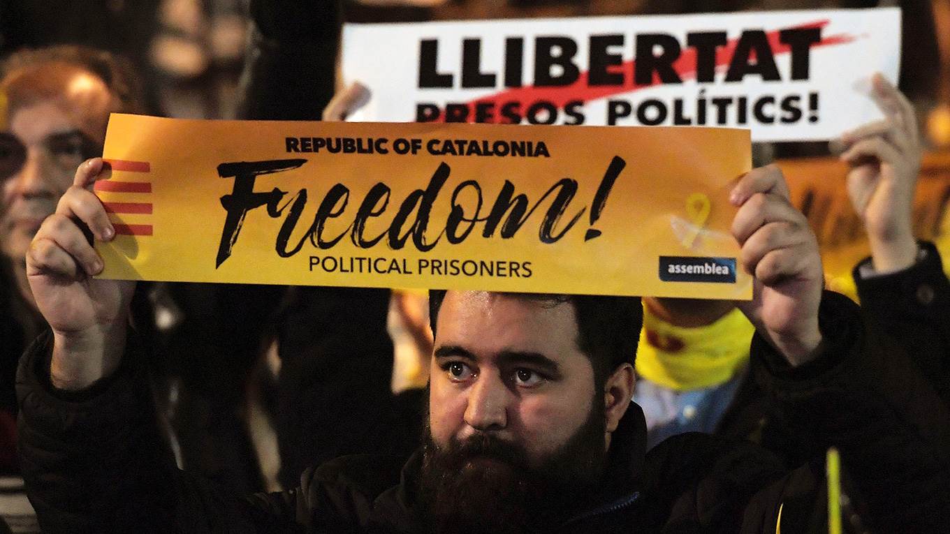 Protesters hold banners reading 'Freedom for political prisoners'