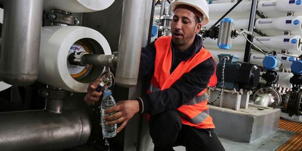 An employee works at a desalination plant