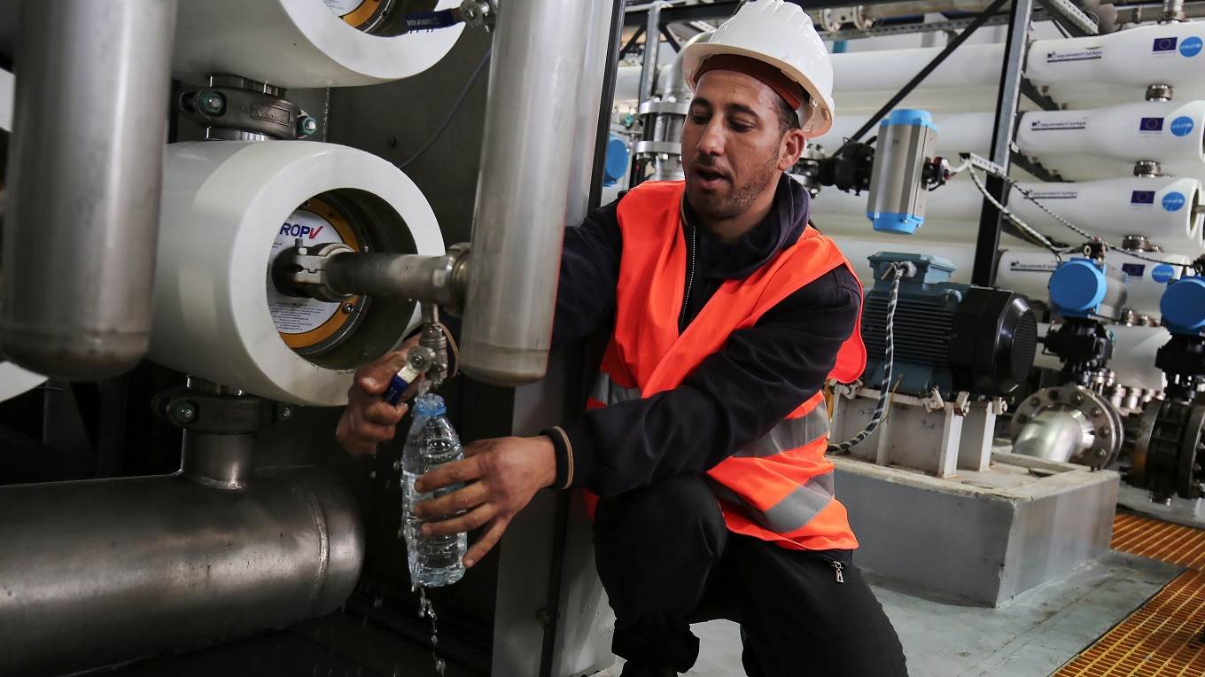 An employee works at a desalination plant