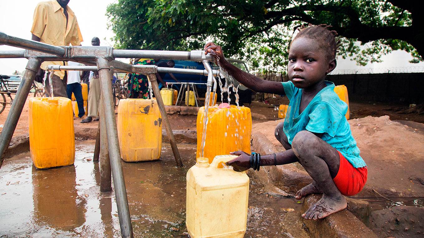 A child collects water from a water point in Juba