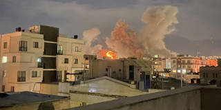 Plumes of smoke rising over Araqi Street in Tehran following explosions near Iran's Ministry of Intelligence on March 1, 2026, after the killing of Ayatollah Ali Khamenei, with streets and buildings partially obscured by smoke.
