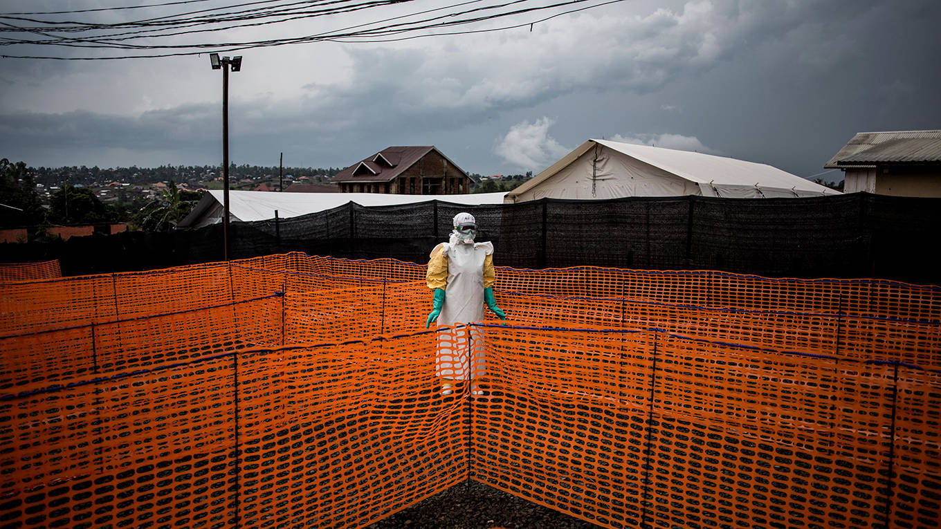 brundtland5_JOHN WESSELSAFPGetty Images_ebolaworkerorangefence