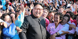Kim Jong-Un attending a photo session with teachers